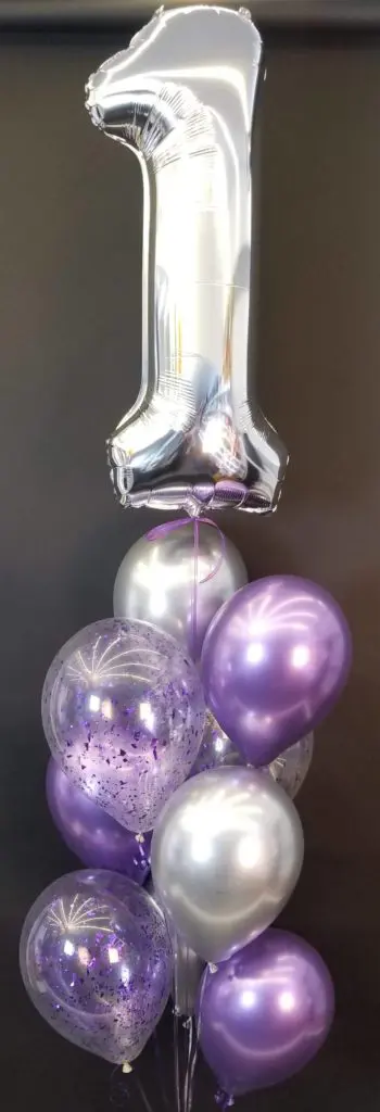 A beautiful balloon centerpiece in chrome purple, pearl lavender, and silver colors, featuring silver number 1 balloons, created by Balloons Lane in Staten Island for a first birthday.
