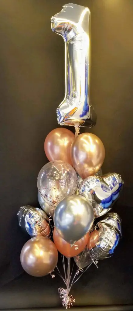 Balloons Lane uses colors Rose Gold and Silver balloons With Number Balloons 1 in Silver Balloons Bouquet for first birthday party balloons