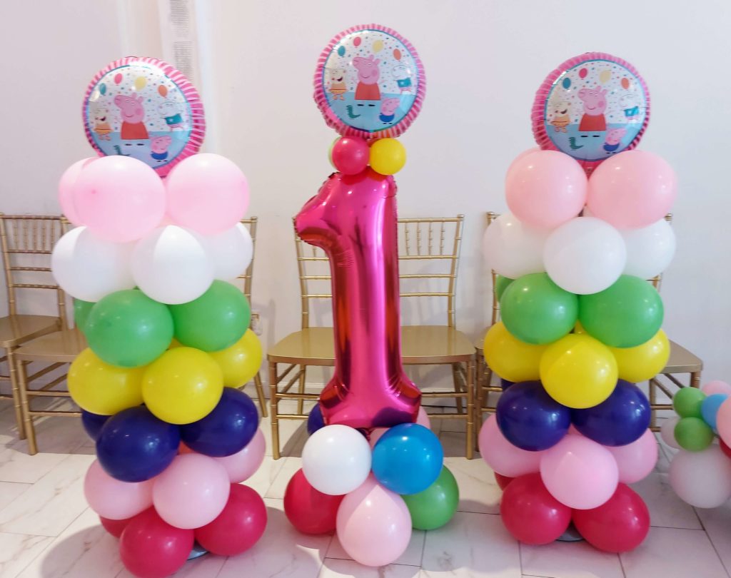 Balloons Lane Balloon delivery NYC in using colors Ruby Red Pink Blue Dark blue Green Yellow Magenta and White balloons With Number balloons 1 in Magenta Arch for one year old birthday