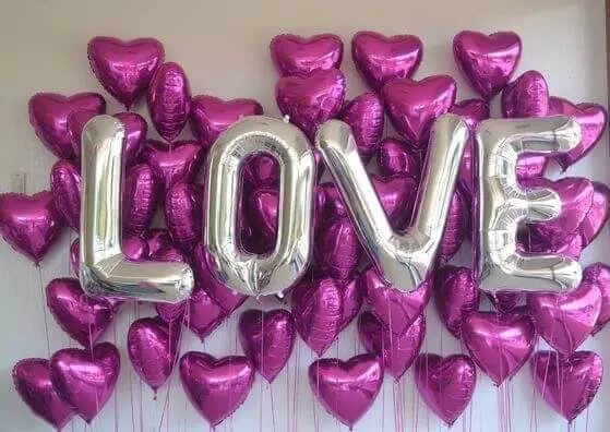 Balloon Lane uses the colors purple and silver with purple heart mylar balloons with big silver romantic decorating ideas for valentines day