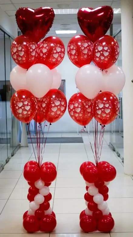 Red, white, and red heart-shaped balloons for Valentine's Day decor.