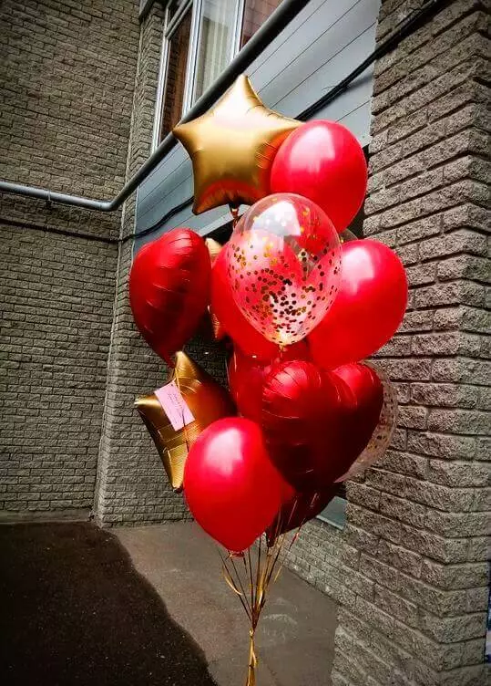 Red, gold, and chrome red gold mylar star with red heart, gold confetti, and red latex balloons for Valentine's Day decor.