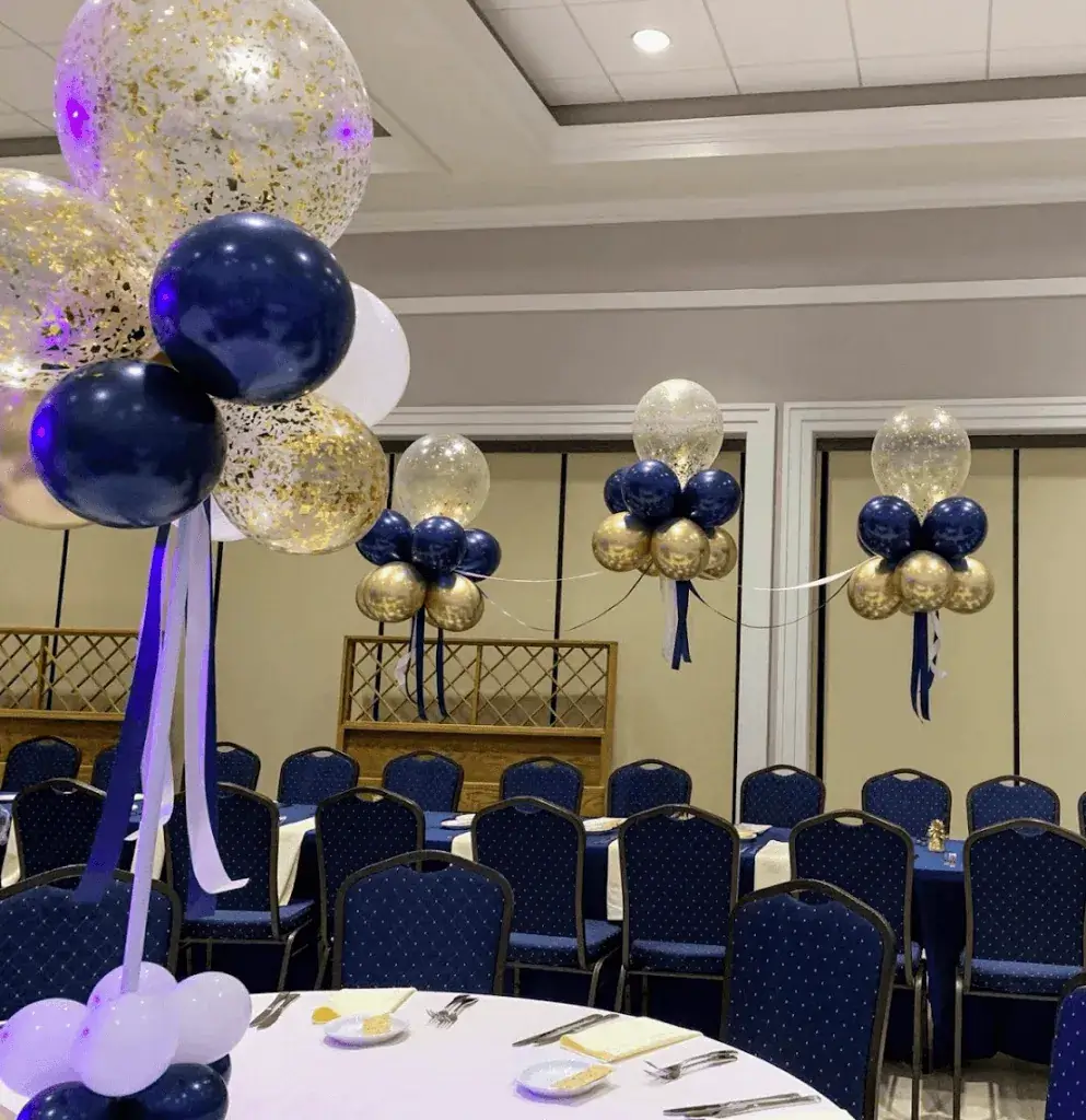 A beautiful balloon bouquet featuring a Bar Mitzvah confetti balloon, white and blue balloons, and white and blue ribbon bows, perfect as a centerpiece for a Bar Mitzvah celebration.