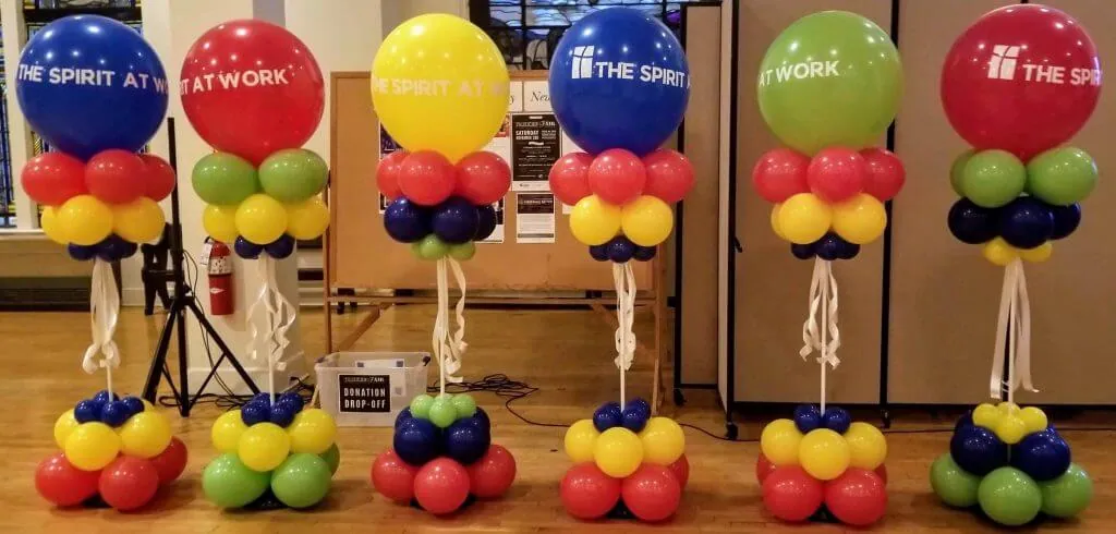 A colorful and customized balloon column featuring big round balloons and small balloons in the same color scheme, with a white bow, perfect for adding a festive touch to any event.