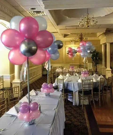 Festive balloon display with pink, silver, and white garland, representing Balloons Lane.