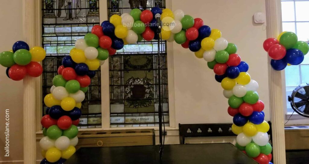 Balloon delivery in Staten Island features Easter arch balloons in an array of colorful balloons in shades of green, purple, pink, yellow, dark blue, orange, and light purple for Easter party decorations.