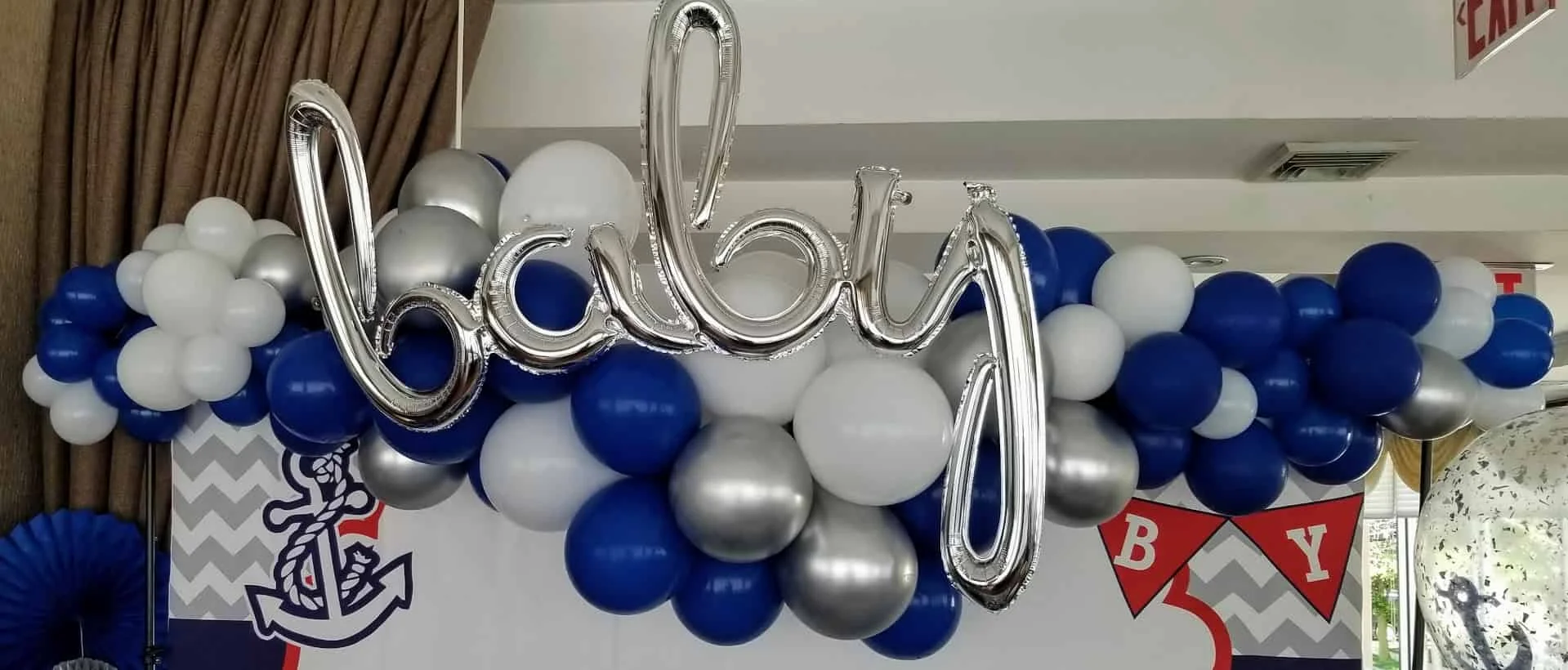 Balloons Lane's Brooklyn creation - a stunning balloon arch decoration in azure, silver, and dark blue for various events.
