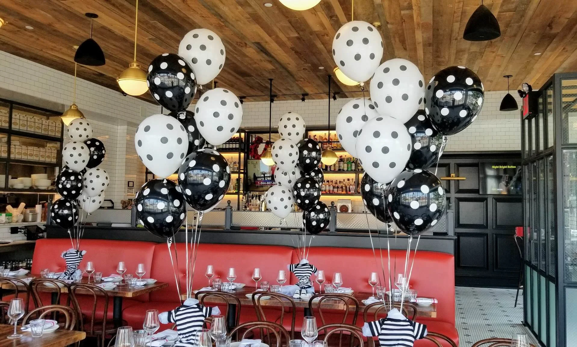 Stylish polka dot balloon decorations by Balloons Lane in Brooklyn, featuring a mix of black and white balloons for party centerpieces.