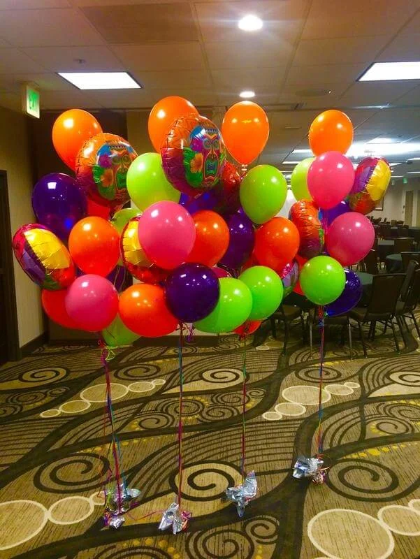 Birthday party balloons in vibrant colors of orange, green, red, dark pink, yellow, and neon, arranged in a stylish column. Perfect for celebrations in Staten Island.