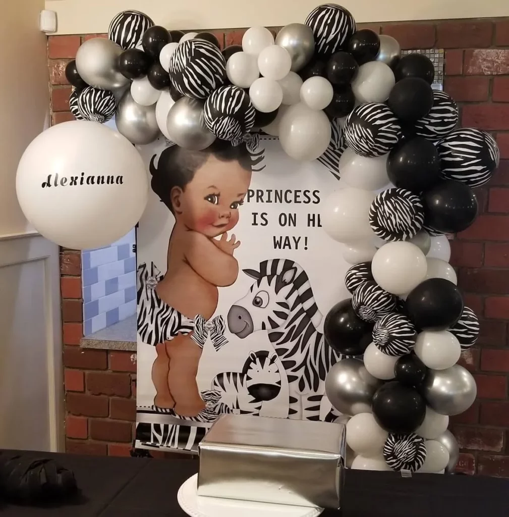 Stylish centerpieces featuring a mix of black, white, and silver balloons, along with zebra-striped print balloons, perfect for adding sophistication and fun to various events.