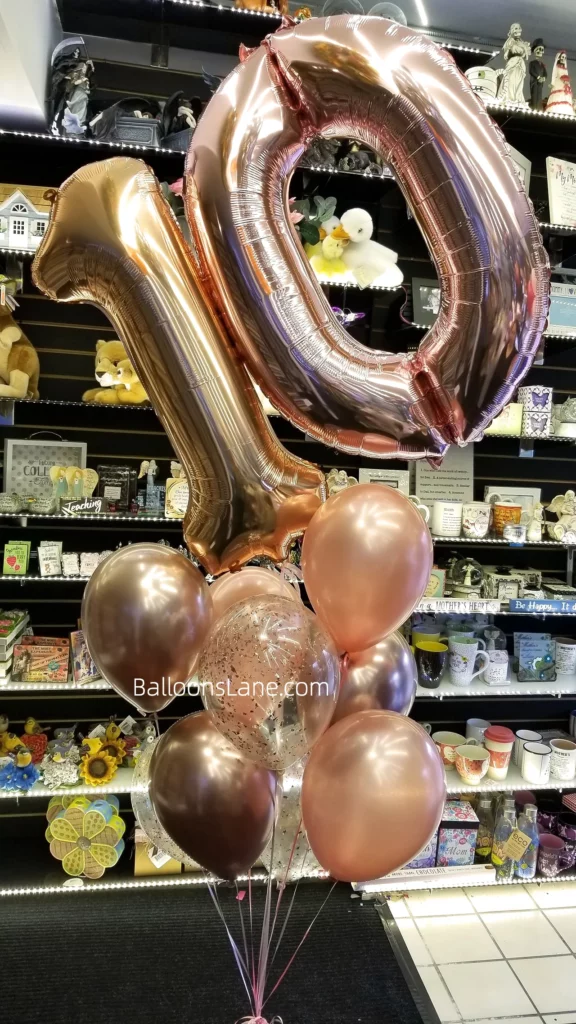 10 birthday party balloons in chrome rose gold and chrome gold, arranged in bouquet to celebrate 10th birthday in NJ.