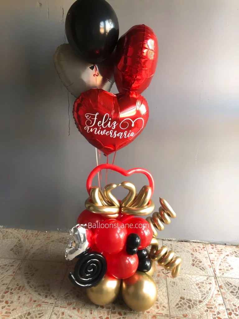 Bouquets of heart-shaped balloons in red, gold, black, and silver colors, accented with twisted balloons.