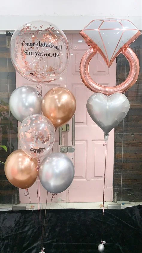 Rose gold ring balloon surrounded by a bouquet of silver and pink confetti balloons and a silver heart-shaped balloon in Brooklyn