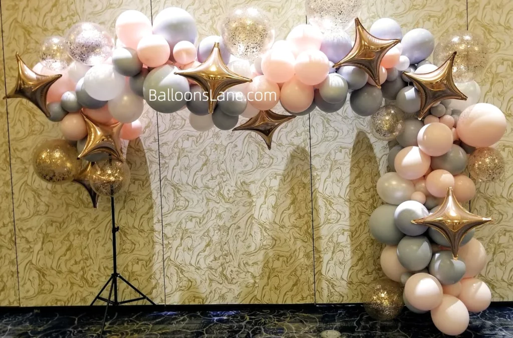 Half arch of pink, grey, white, and gold latex balloons, confetti balloons, and star foil balloons, perfect for celebrating various events.