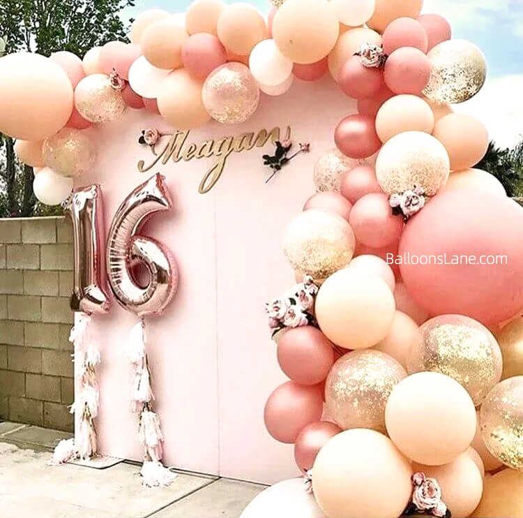 Rose gold number 1 & 6 balloons with peach pink, rose gold balloons, and confetti balloons arranged in a half arch in Brooklyn