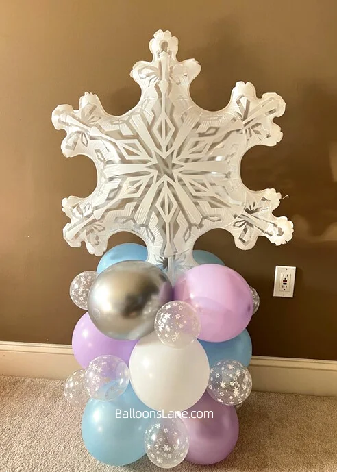 A large white snowflake balloon accompanied by lavender, silver, and blue balloons.