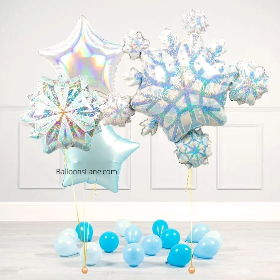 A Winter Wonderland snowflake balloon surrounded by silver and blue star balloons, along with latex balloons in different shades of blue.