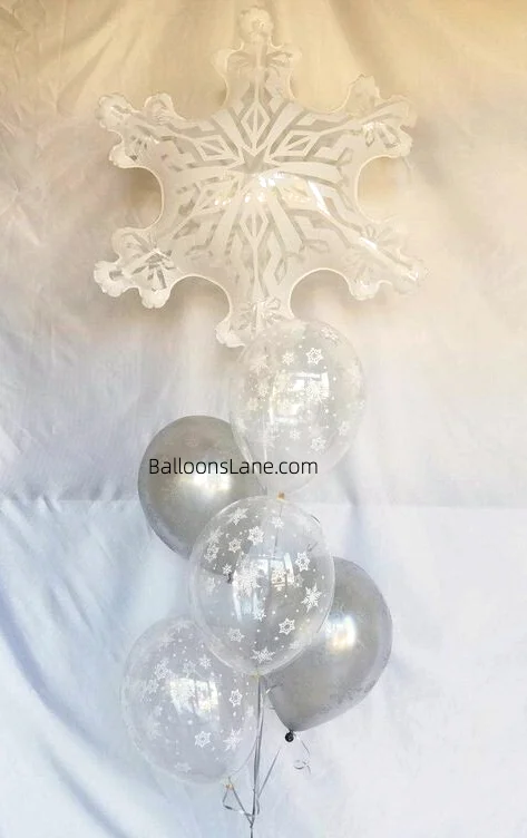 A white snowflake balloon paired with clear printed balloons and silver latex balloons.