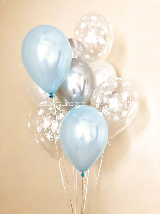A bunch of blue and silver balloons paired with clear white printed balloons.