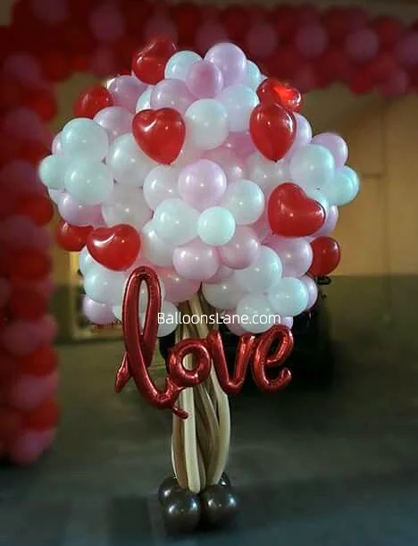 Red heart-shaped balloons with "Love" letter foil balloons.