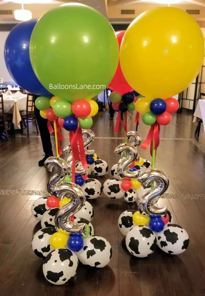 Dark blue, green, yellow, black, and white printed balloons along with twisted colorful balloons for 2nd birthday party in New Jersey