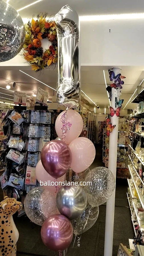 1st birthday balloons bouquet with silver confetti, pink, and chrome pink balloons, along with number "1" balloon in Staten Island