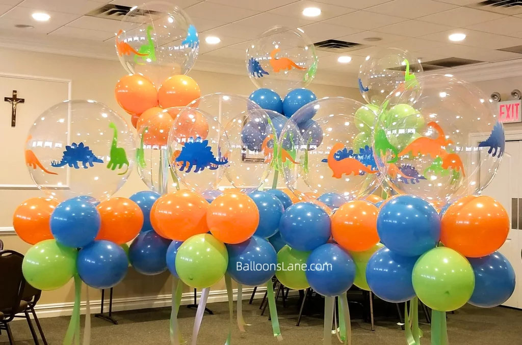 Large dinosaur-themed bubble balloon with orange, blue, and green bouquet in Staten Island