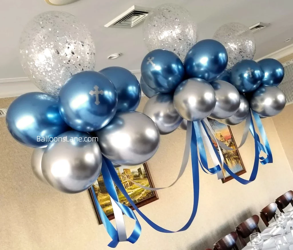 Balloon bouquet for christening featuring silver and blue balloons with a cross-shaped Mylar balloon in Staten Island.