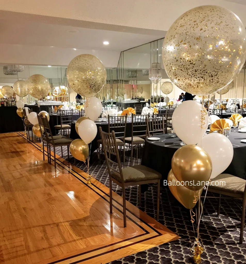 Large confetti balloon stands with white and gold balloons to celebrate anniversary in Brooklyn