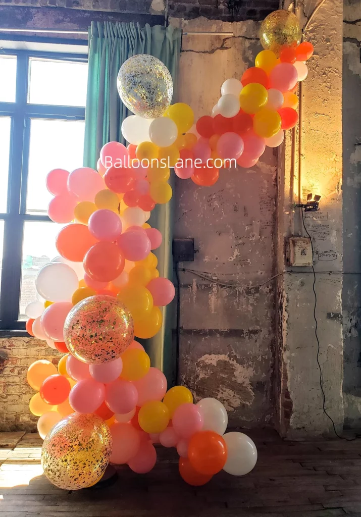 Beautiful Balloon Garland in Pink, Yellow, Orange, White, and Gold Confetti for Celebrating Special Occasions like Birthdays and Engagements in Brooklyn
