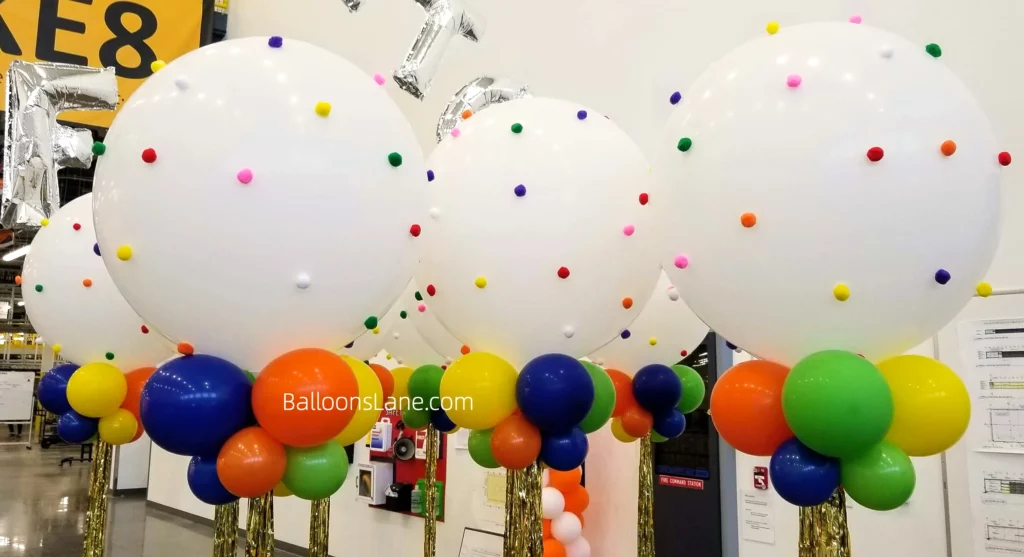 White giant balloon with multi-color balloon bouquet in orange, blue, yellow, and white in New York City