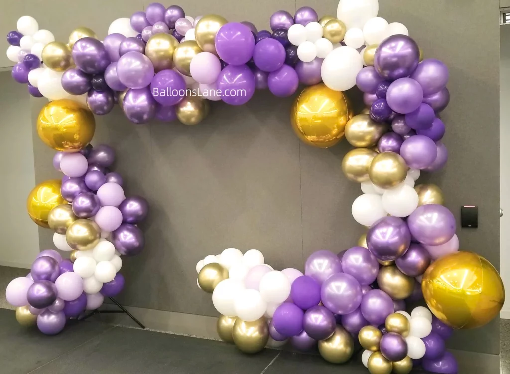 Lavender, gold, and white balloons arch to celebrate engagement, anniversary in NYC.