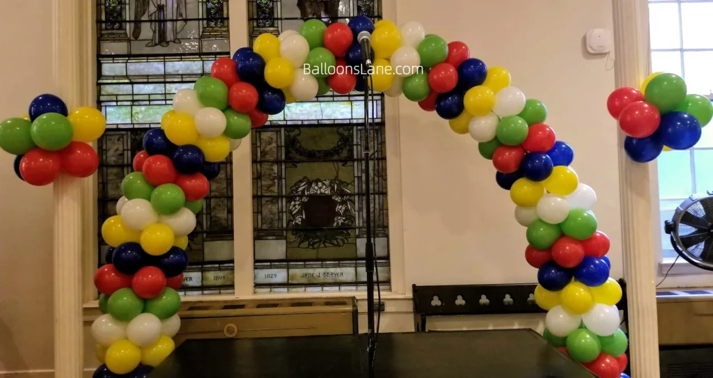 olorful balloon arch in red, yellow, blue, and green, with matching balloon clusters, perfect for celebrating Sports Day.