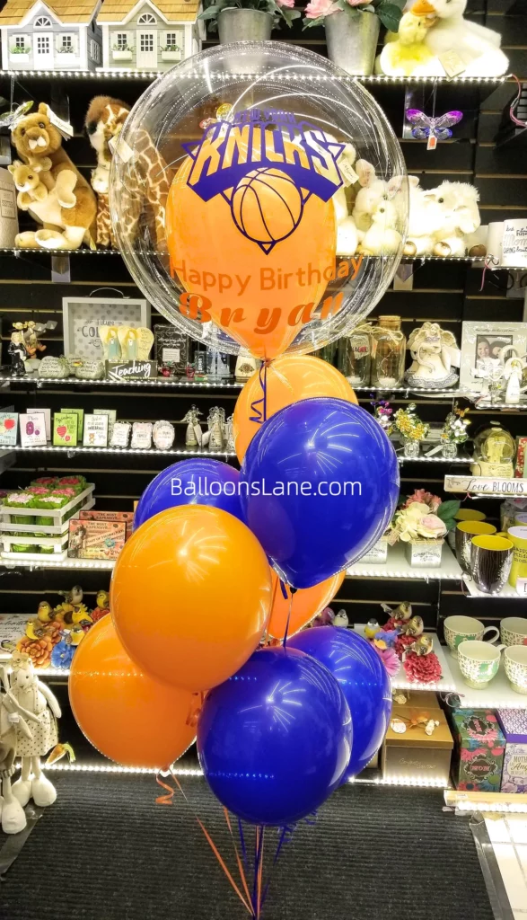 Sports day celebration with feather balloon, orange, and blue balloon bouquet in Brooklyn.