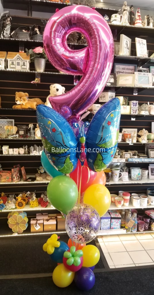 Pink Number Balloon with Butterfly Theme Balloons, Surrounded by Yellow, Blue, and Pink Balloons, Perfect for a Birthday Celebration in Staten Island