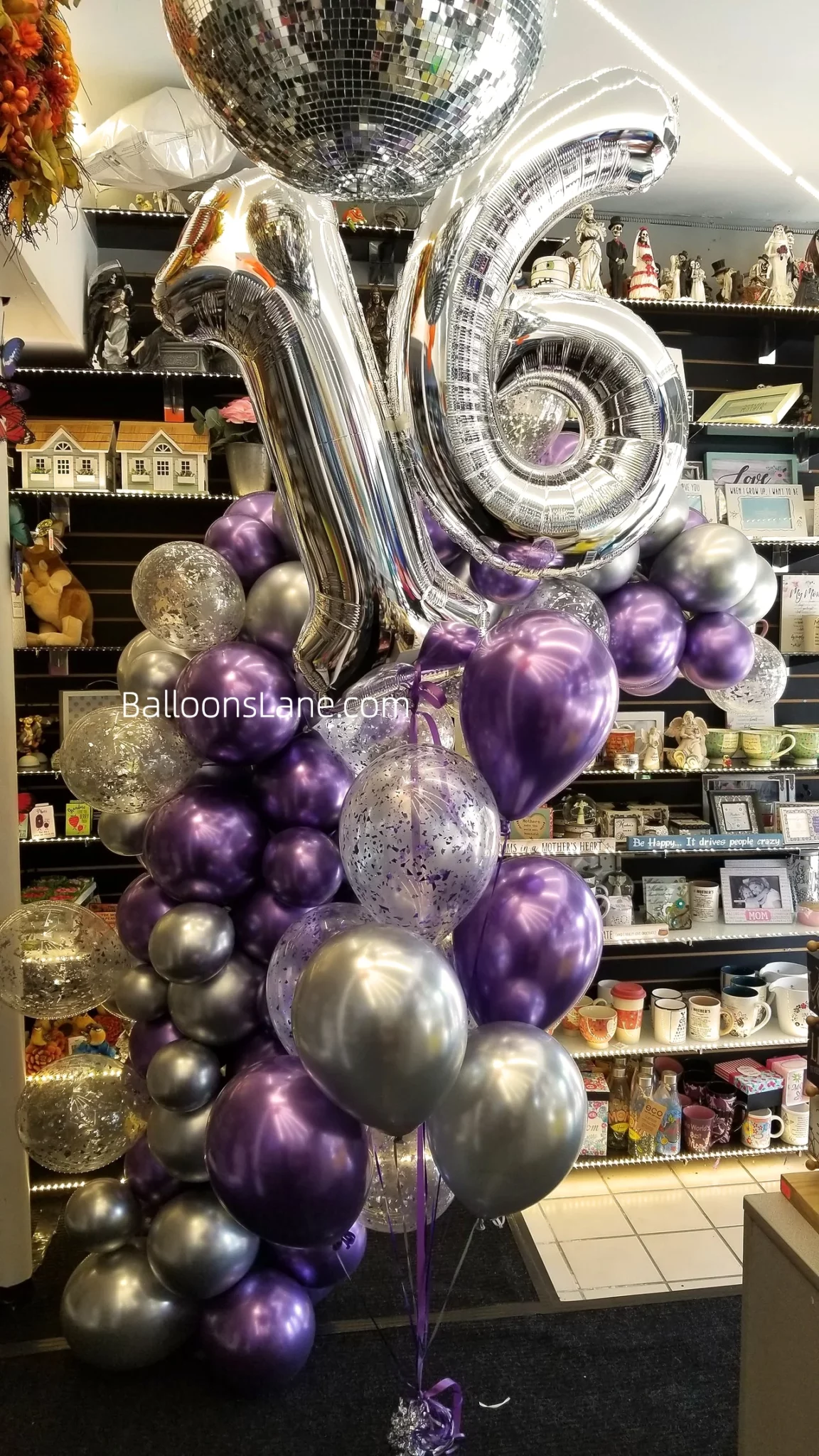 A bouquet arrangement featuring lavender balloons, silver balloons, and confetti balloons, along with number 1 & 6 balloons.