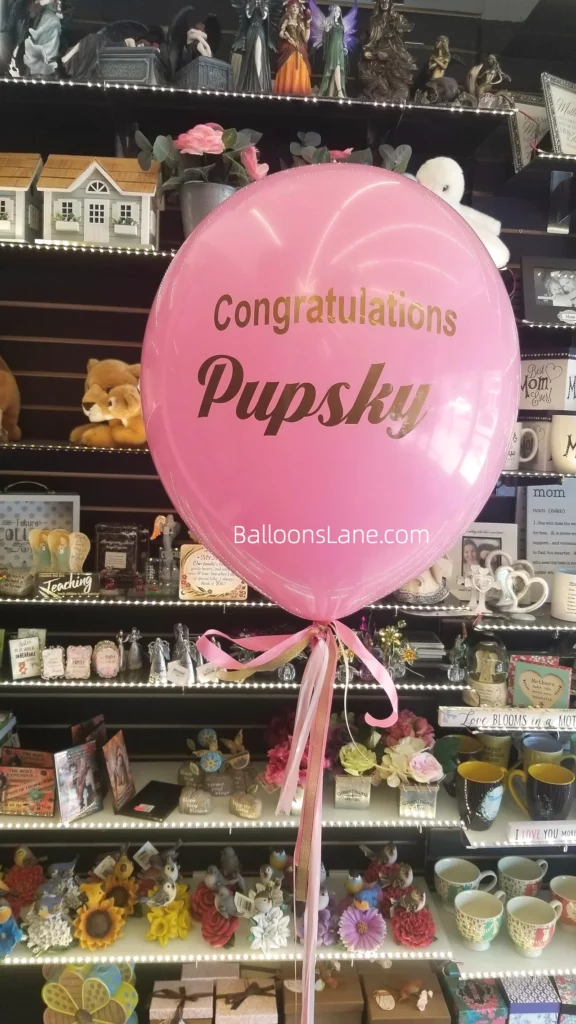 Personalized balloon with "Congratulations" message.