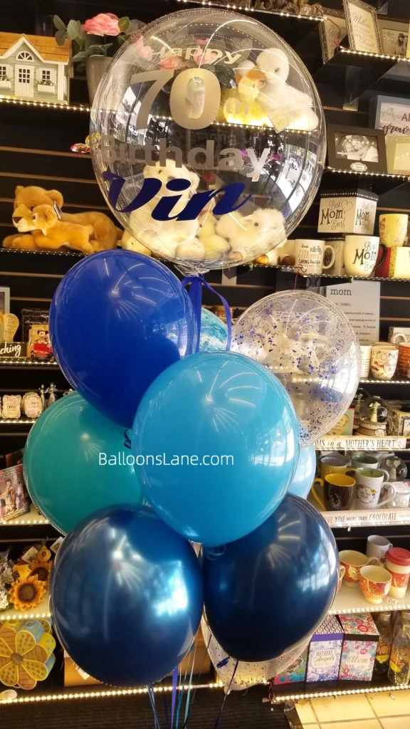 70th birthday customized bubble balloon along with blue, navy blue, chrome blue, and blue confetti balloons in Manhattan.