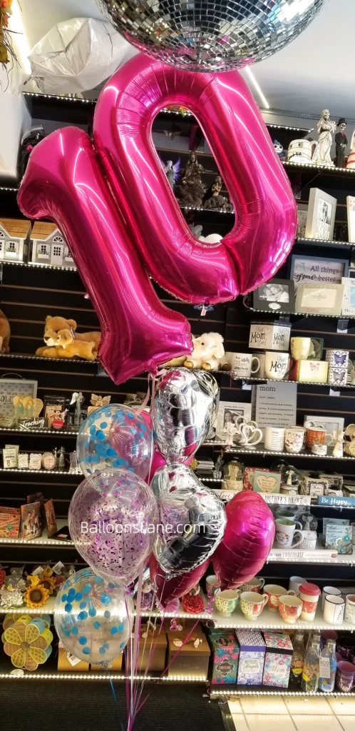 10 pink number balloons with silver heart-shaped balloon, pink and blue confetti balloons arranged in bouquet to celebrate in style in Brooklyn.