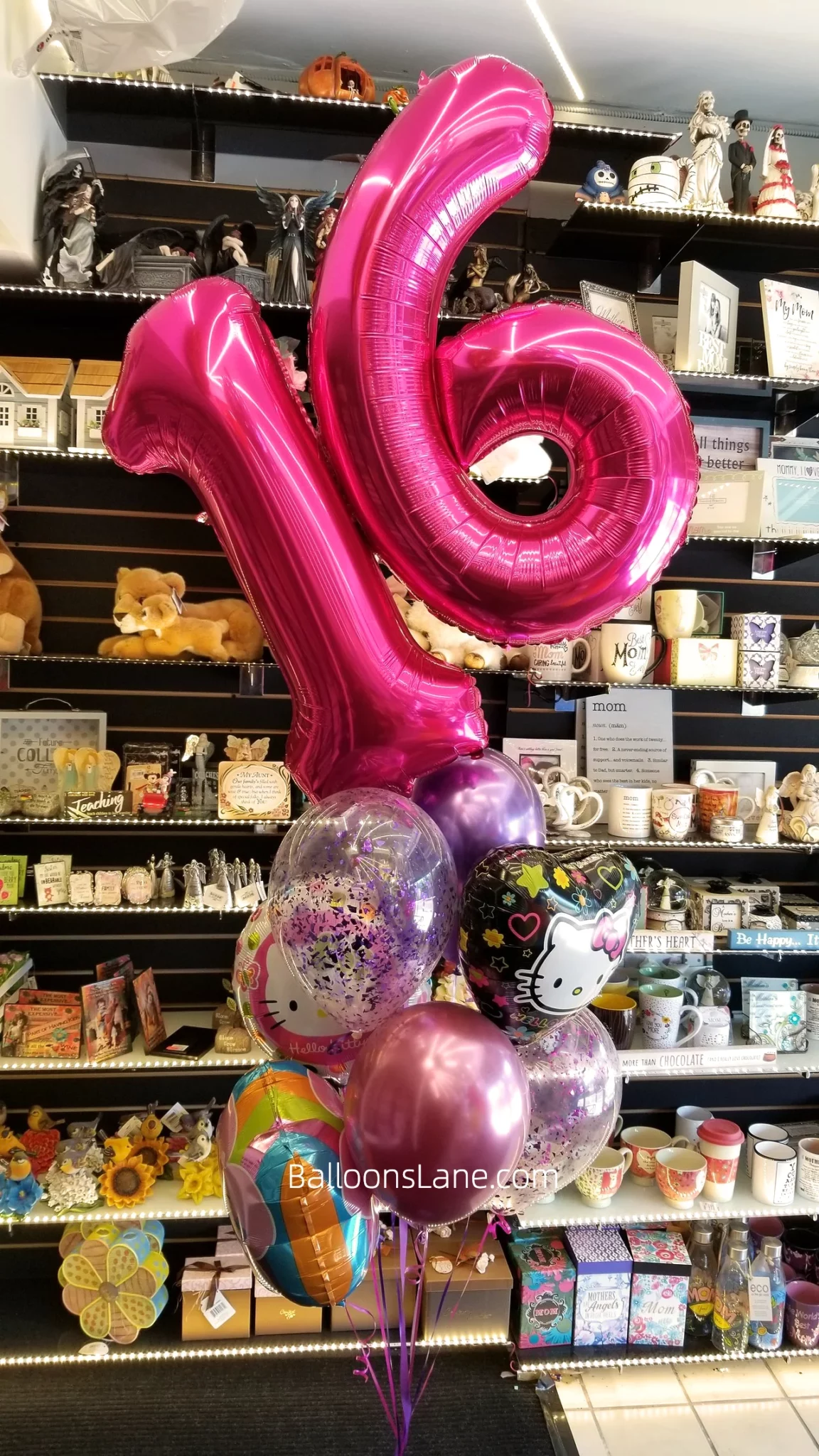 Sweet Sixteen number balloons in blush pink, accompanied by a bouquet featuring pink balloons, silver heart-shaped balloons, character balloons, and pink confetti balloons.