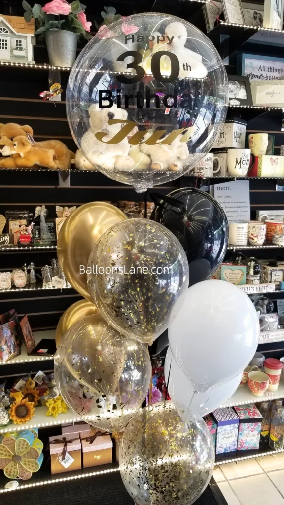 Birthday feather balloons accompanied by confetti, gold, white, and black balloons, along with customized 30th birthday balloons, in Brooklyn.