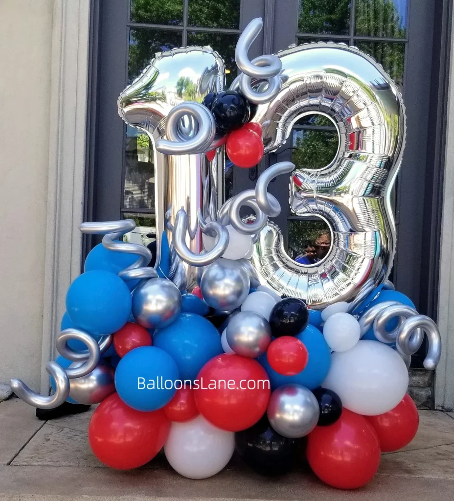 13 large silver balloons with silver twisted balloons and blue, red, black and silver latex balloon bouquets to celebrate 13th birthday in NYC.