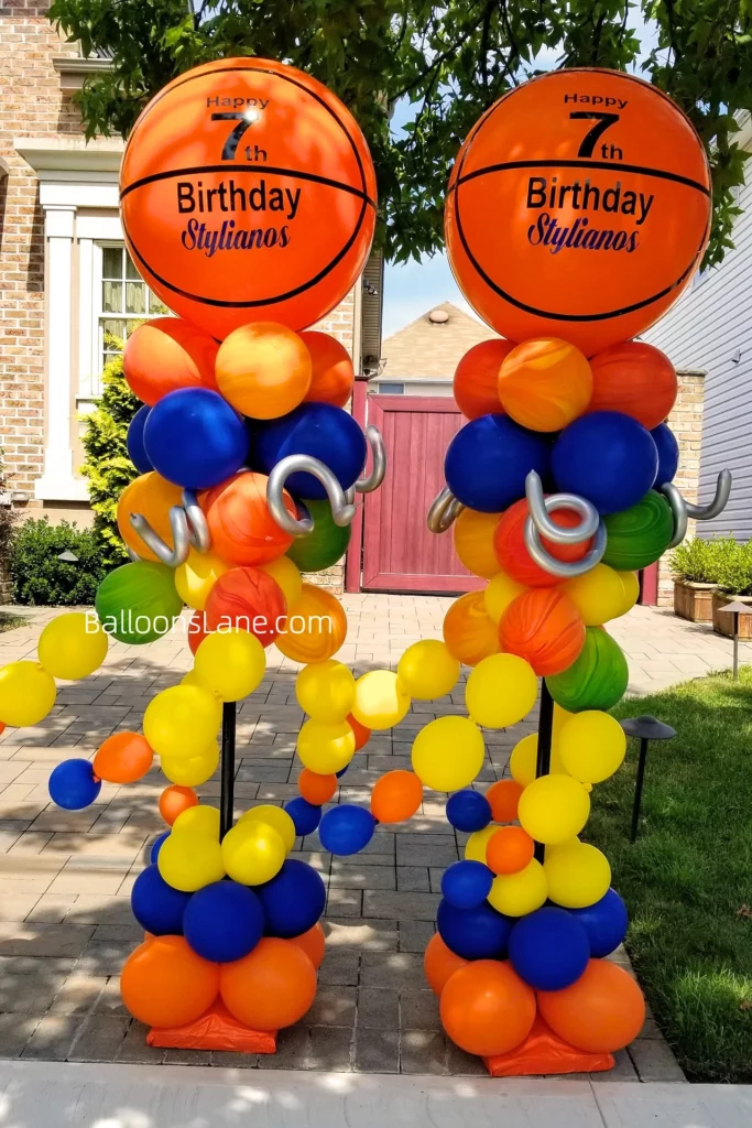 Happy 7th birthday balloon bouquet with yellow, orange, blue, and green balloons, and a large orange personalized balloon in NYC.