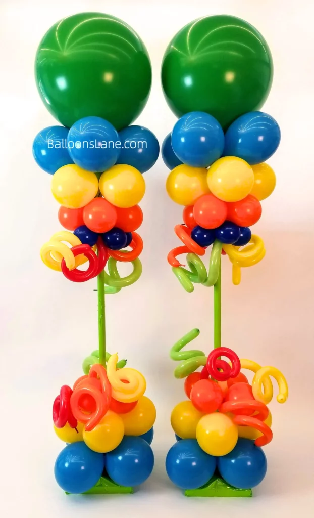 Multi-color balloon column with latex green, blue, orange, and purple balloons along with twisted balloon in NYC