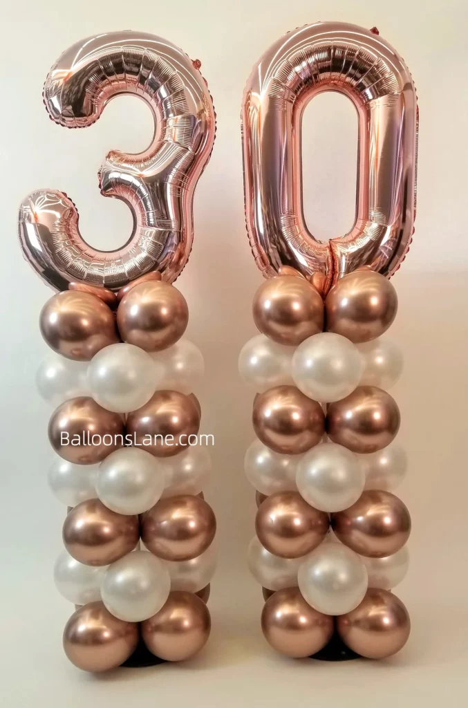 30 large rose gold number balloons surrounded by matching colors, white latex and confetti balloons arranged in a column in Brooklyn.