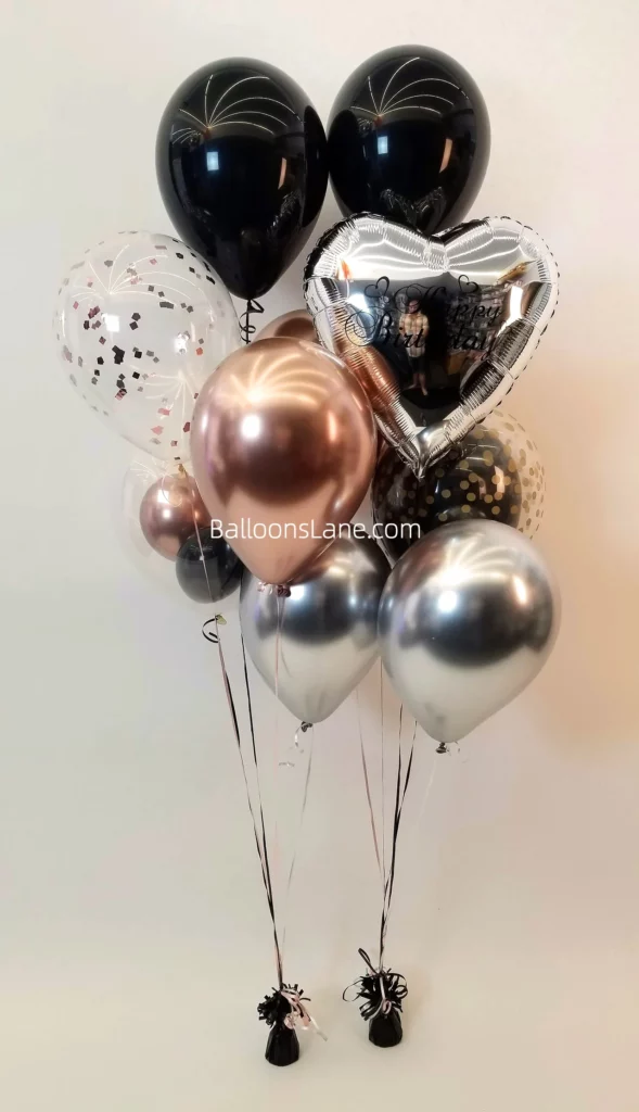 Silver heart, black, rose gold confetti, and chrome silver balloon bouquet to celebrate a birthday at Manhattan.