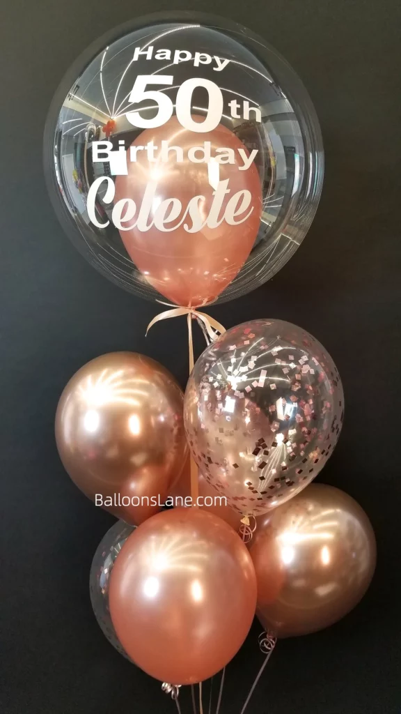 Happy 50th birthday balloon bouquet with rose gold latex balloons and confetti balloons in NYC.