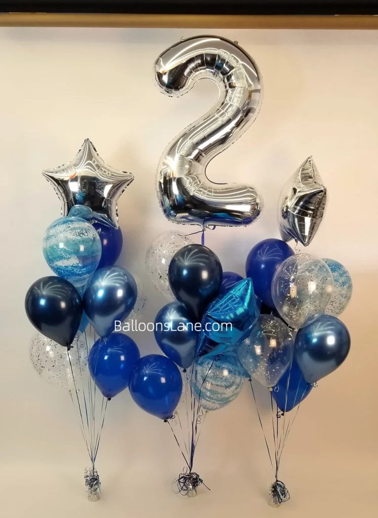 The delightful bouquet featured a silver "2" mylar balloon surrounded by blue latex balloons, accented with a large silver and blue star balloon, and a blue confetti balloon.