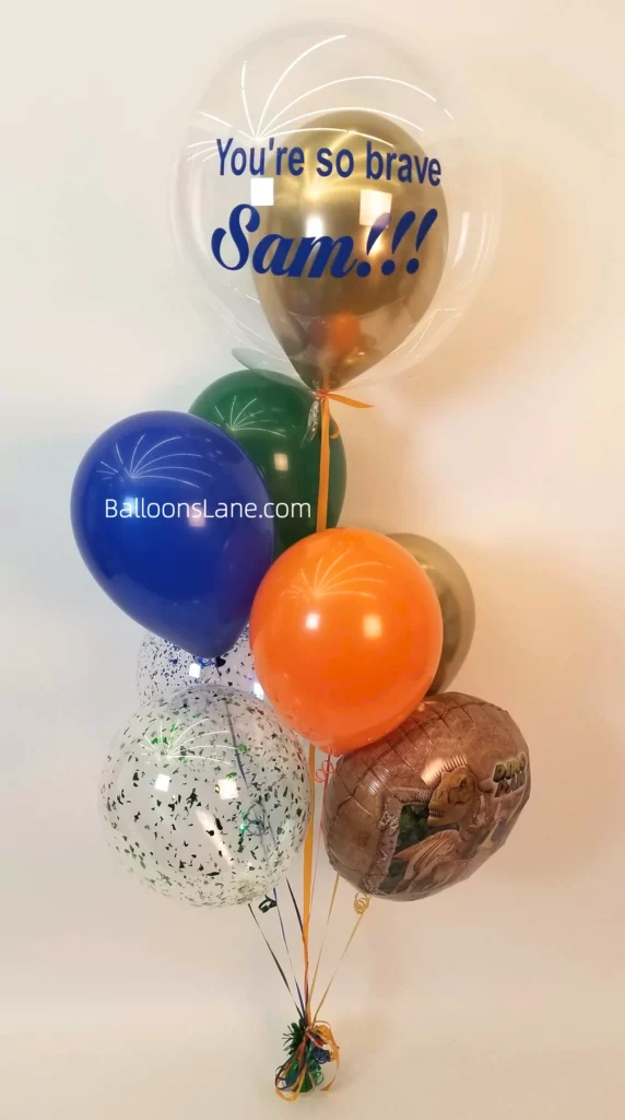 Customized balloon bouquets with orange, blue, and green confetti balloons in NYC.