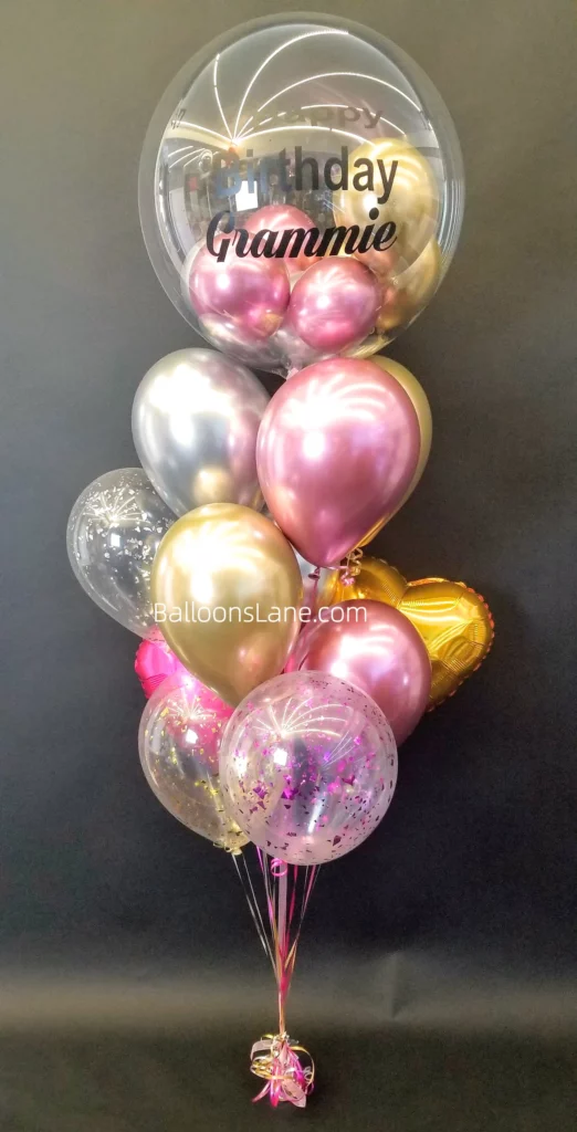 Happy birthday customized balloon bouquet with rose gold, silver, and pink latex balloons, along with a gold heart balloon and confetti balloon in NYC.